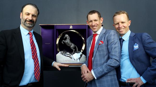 Racing NSW CEO Peter V'landys inspects The Everest trophy with high-profile jockeys Hugh Bowman and Kerrin McEvoy.