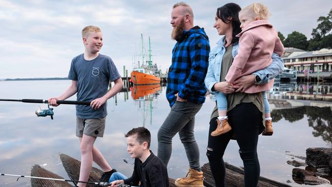 Adam ‘Salty’ Saltmarsh, a salmon industry worker, in Strahan on Tasmania’s west coast, with his wife Samantha and children Logan, 12, Hudson., 9, and Paisley, 4. Picture: Peter Mathew