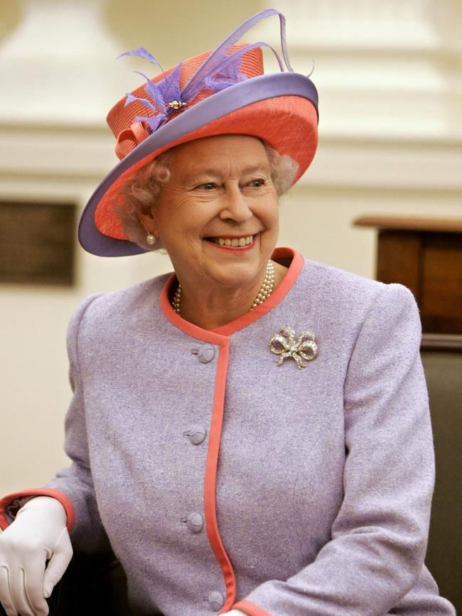 Queen Elizabeth II, pictured here in the US in 2007, wore an orange and lilac ensemble. Picture: AFP