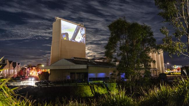 Video of a LifeFlight pilot is projected onto a Mills Precinct structure for the LifeFlight Toowoomba Gala at The Goods Shed, Saturday, May 6, 2023. Picture: Kevin Farmer