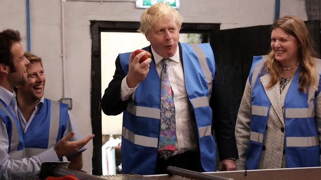 British PM Boris Johnson tries an apple as he visits Healey's Cornish Cyder Farm in Callestick, England. Picture: Getty Images