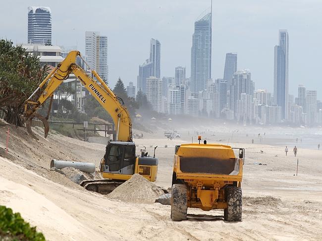 Gold Coast City Council trucks and heavy equipment work on the beach at Nobby Beach. Pic: Glenn Hampson