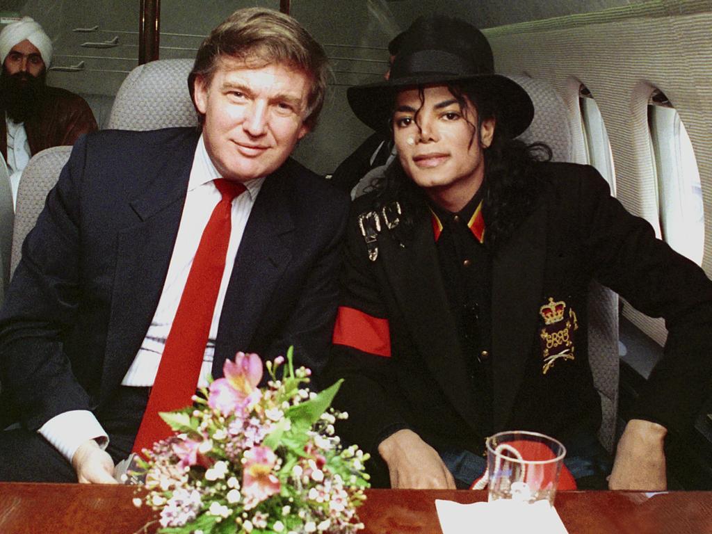 Donald Trump and Michael Jackson are seen onboard a private plane on April 1, 1990. Picture: Donna Connor/FilmMagic