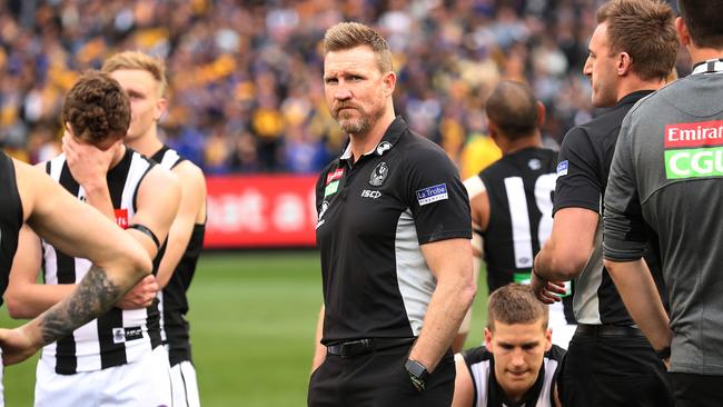 Nathan Buckley and dejected Collingwood players after the 2018 Grand Final.