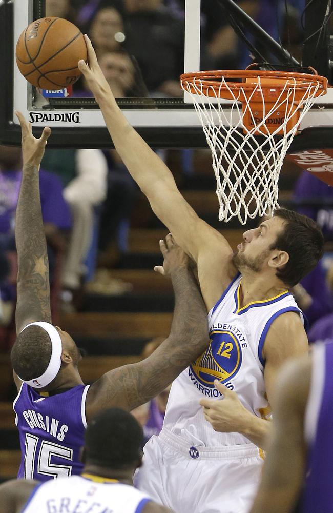 Andrew Bogut swats away DeMarcus Cousins in Sacramento.