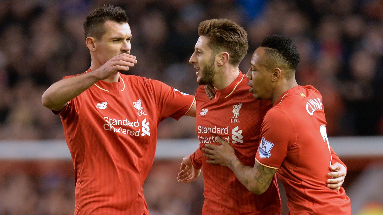 Liverpool's English midfielder Adam Lallana (C) celebrates with Liverpool's Croatian defender Dejan Lovren (L) and Liverpool's English defender Nathaniel Clyne after scoring the opening goal of the English Premier League football match between Liverpool and Manchester City at Anfield in Liverpool, northwest England on March 2, 2016. / AFP / Paul ELLIS / RESTRICTED TO EDITORIAL USE. No use with unauthorized audio, video, data, fixture lists, club/league logos or 'live' services. Online in-match use limited to 75 images, no video emulation. No use in betting, games or single club/league/player publications. /