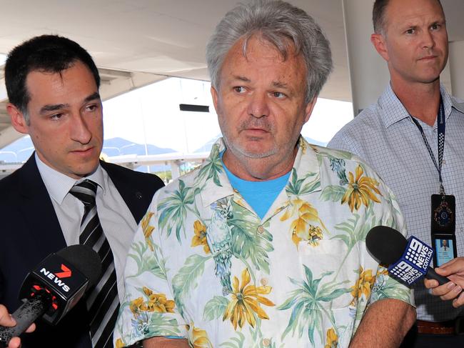 Peter Foster being police escorted through Cairns airport en route to Sydney. Picture: Stewart McLean