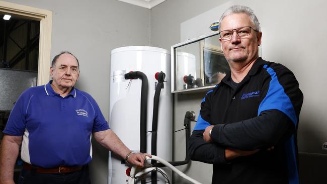 Plumber Bill Armstrong, board member of the Master Plumbers NSW, (left) with Tim Mackie owner of Kirrapak in Braemar who had two hot water system installed in his factory with one breaking down after only one month. Picture: Jonathan Ng