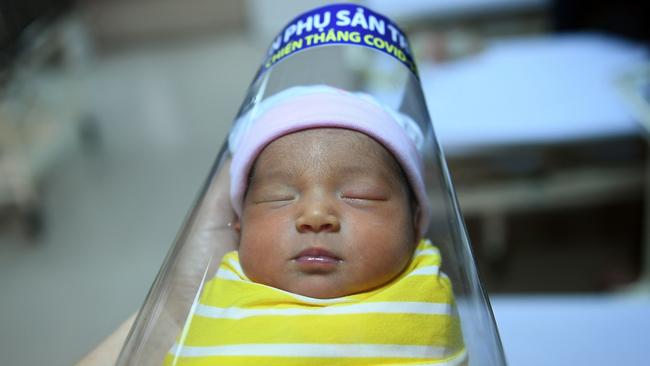 A newborn baby wearing a face shield at the National Maternity Hospital in Hanoi, Vietnam. Picture: AFP