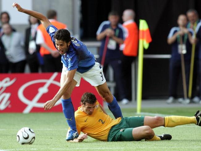 Australia’s Lucas Neill goes to ground... and Italy’s Fabio Grosso follows suit. Pic: AFP