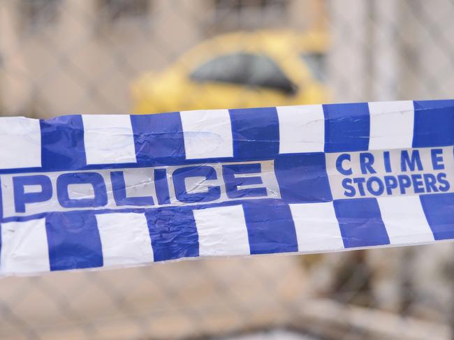 Blue and white Police tape cordoning off a area with a yellow car at a industrial area, Australia 2016 Police tape cordoning off a area with a yellow car - Stock image ipad generic