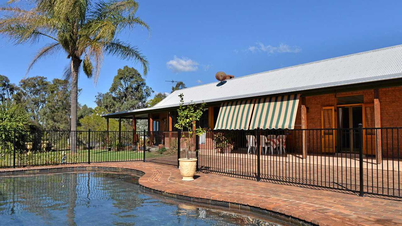 The brick home comes with a pool.