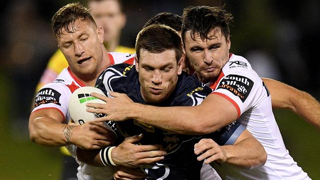 Cowboys centre Tom Opacic couldn’t escape the clutches of Tariq Sims and Lachlan Maranta. Picture: AAP