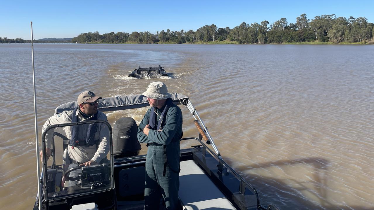 Rangers placing the floating trap in the Fitzroy River to remove the crocodile.