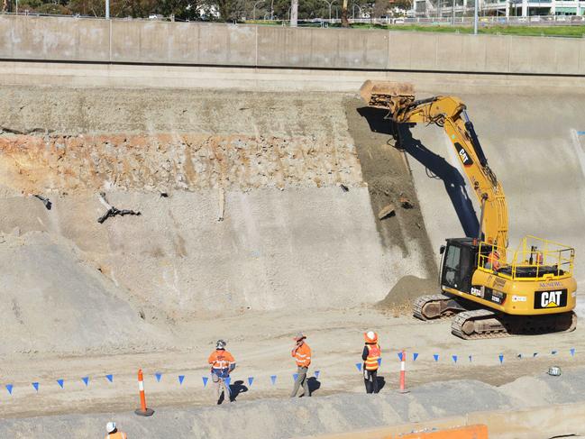 Work starts to tear down the existing shotcrete between the two sections of embankment that collapse on the South Rd Darlington upgrade. Picture: Brenton Edwards