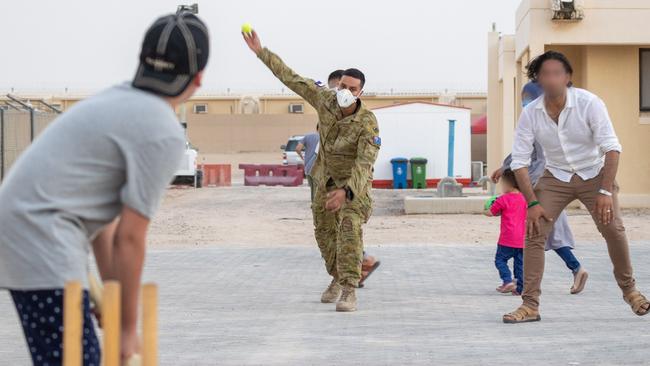 Australian Army Private Lachmaiya plays cricket with Afghanistan evacuees at the temporary camp in Australia's main operating base in the Middle East. Picture: Supplied/Australian Department of Defence