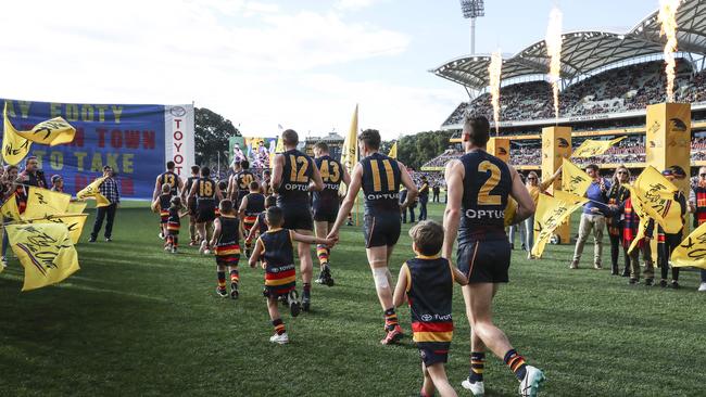 The Crows run out in front of a packed house for the start of Showdown 47. Picture SARAH REED