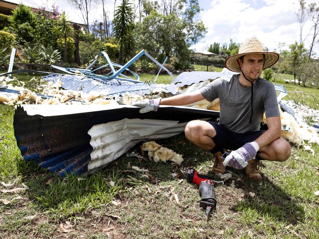 Chris Ikin at his grandmother’s house at Mundoolun where the neighbours’ roof landed in their back yard. Picture: Nigel Hallett