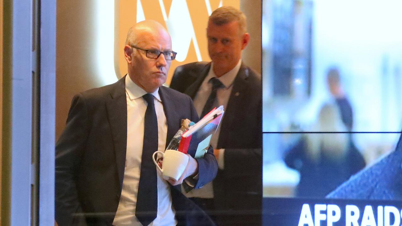 John Lyons, executive editor of ABC News, is followed by an Australian Federal Police officer out of the ABC building in Sydney. Picture: AAP