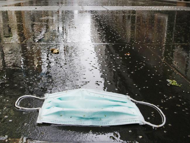 Melbourne City streets lunch time rush under COVID lock down restrictions. A discarded face mask on the deserted footpath in Swanston street.   Picture: David Caird