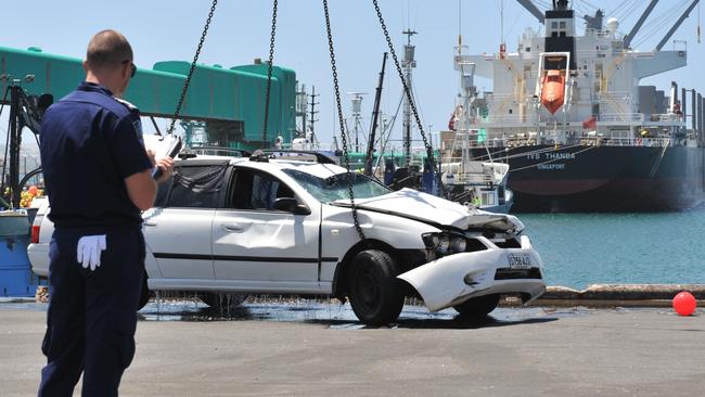 The Ford Falcon station wagon is lifted from the water onto the Port Lincoln wharf. Picture: Ivon Perrin