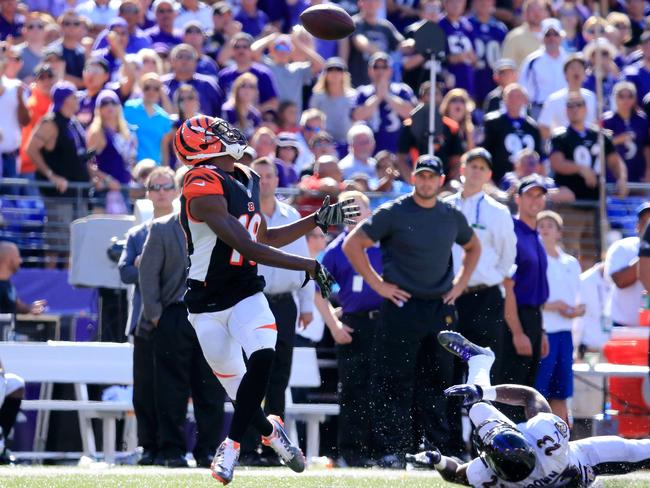 Wide receiver A.J. Green #18 of the Cincinnati Bengals keeps his eye on the ball, before scoring a touchdown on the play, during an NFL football game against the Baltimore Ravens.