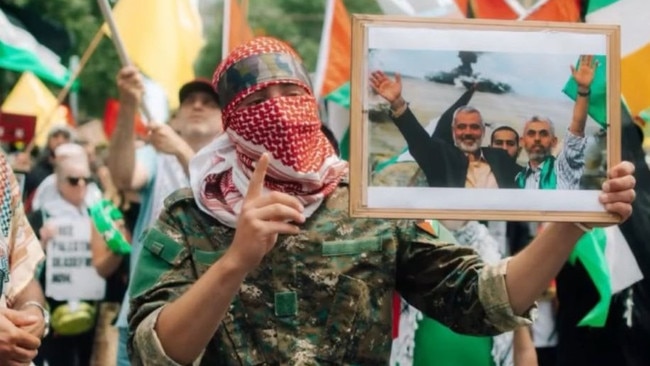 A protester holds a portrait of Sinwar at a rally in Melbourne on Sunday.