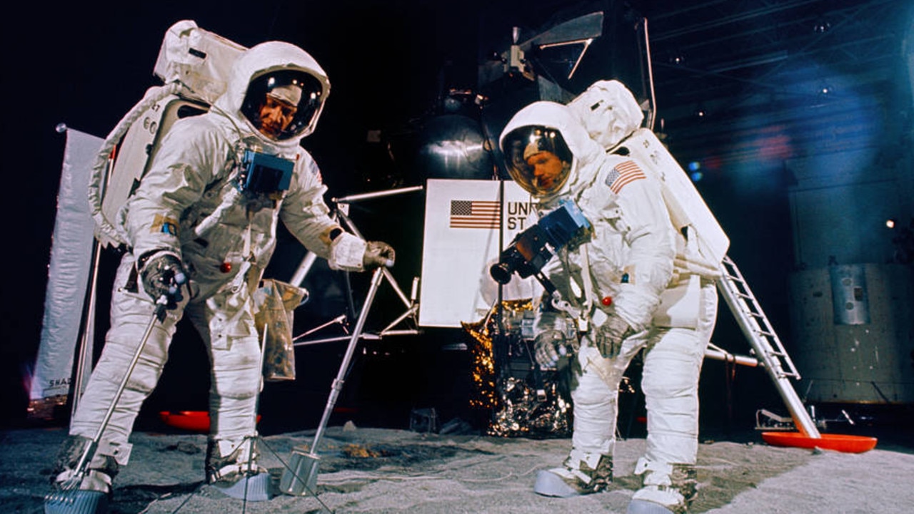 Neil Armstrong and Buzz Aldrin training to collect moon rocks and soil on the moon. Picture: NASA