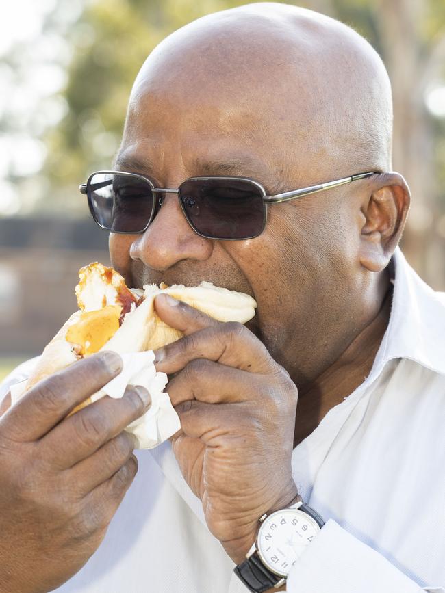 Canterbury Bankstown Express journalist Lawrence Machado tasting the sausage sizzle. Picture: Matthew Vasilescu