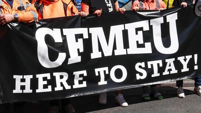 Protesters hold banners and chant slogans as they march in support of the Construction, Forestry and Maritime Employees Union (CFMEU) in central Sydney on September 18, 2024. Thousands of trade workers joined marches in Melbourne and Sydney to protest against the federal government's decision to force the CFMEU's construction arm into administration. (Photo by DAVID GRAY / AFP)