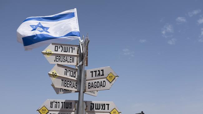 GOLAN HEIGHTS - MAY 10:  (ISRAEL OUT)  A silhouette sculpture of an Israeli soldier standing guard is seen next  to a signs pointing out distance to different cities on Mount Bental next to the Syrian border on May 10, 2018 in the Israeli-annexed Golan Heights. Some 20 rockets were fired at Israeli military bases by Iranian forces from southern Syria just after midnight on Thursday, sparking the largest ever direct clash between Jerusalem and Tehran, with Israeli jets targeting numerous Iranian-controlled sites across Syria. On Monday  U.S. President Donald Trump pulls out of the Iran deal.  (Photo by Lior Mizrahi/Getty Images) *** BESTPIX ***