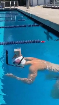 Katie Ledecky doesn't spill a drop as she swims with a glass of milk on her head