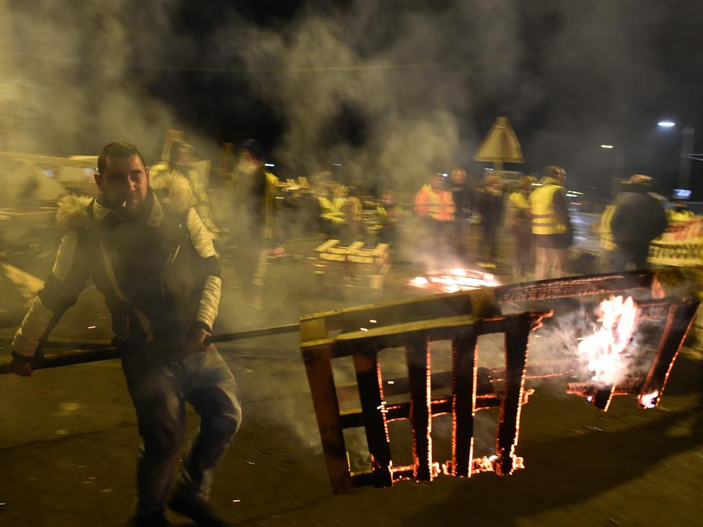 Yellow vests protestors (gilets jaunes) burning barricades after the announcement of imminent police intervention, as they block the access to the oil depot in Le Mans, northwestern France. Picture: Jean-Francois Monier 