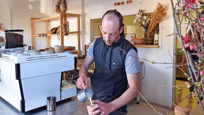 Barista Brad Proctor makes coffees with organic full fat milk. Picture: Troy Snook)