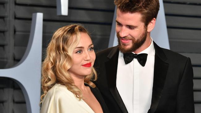 (FILES) In this file photo taken on March 4, 2018 Miley Cyrus (L) and Liam Hemsworth attend the 2018 Vanity Fair Oscar Party hosted by Radhika Jones at Wallis Annenberg Center for the Performing Arts in Beverly Hills, California. - Pop star Miley Cyrus clapped back at her social media haters on August 22, 2019 over her recent split with longtime partner Liam Hemsworth, an Australian actor, to deny allegations that she cheated on him. "I can accept that the life I've chosen means I must live completely open and transparent with my fans who I love, and the public, 100% of the time. What I cannot accept is being told I'm lying to cover up a crime I haven't committed. I have nothing to hide," the 26-year-old superstar tweeted. (Photo by Dia Dipasupil / GETTY IMAGES NORTH AMERICA / AFP)