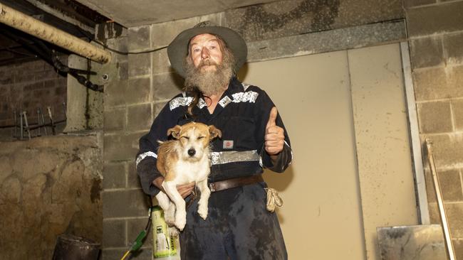 Ian Patton with his dog inside his bunker. Picture: Gary Ramage