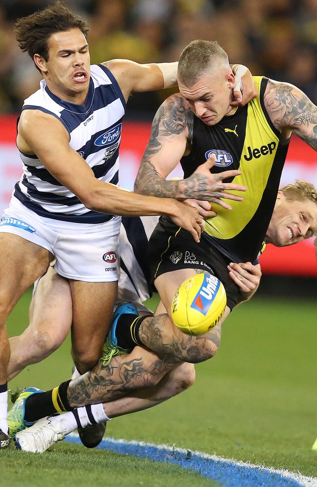 Jamaine Jones and Scott Selwood bring down Dustin Martin. Picture: Michael Klein