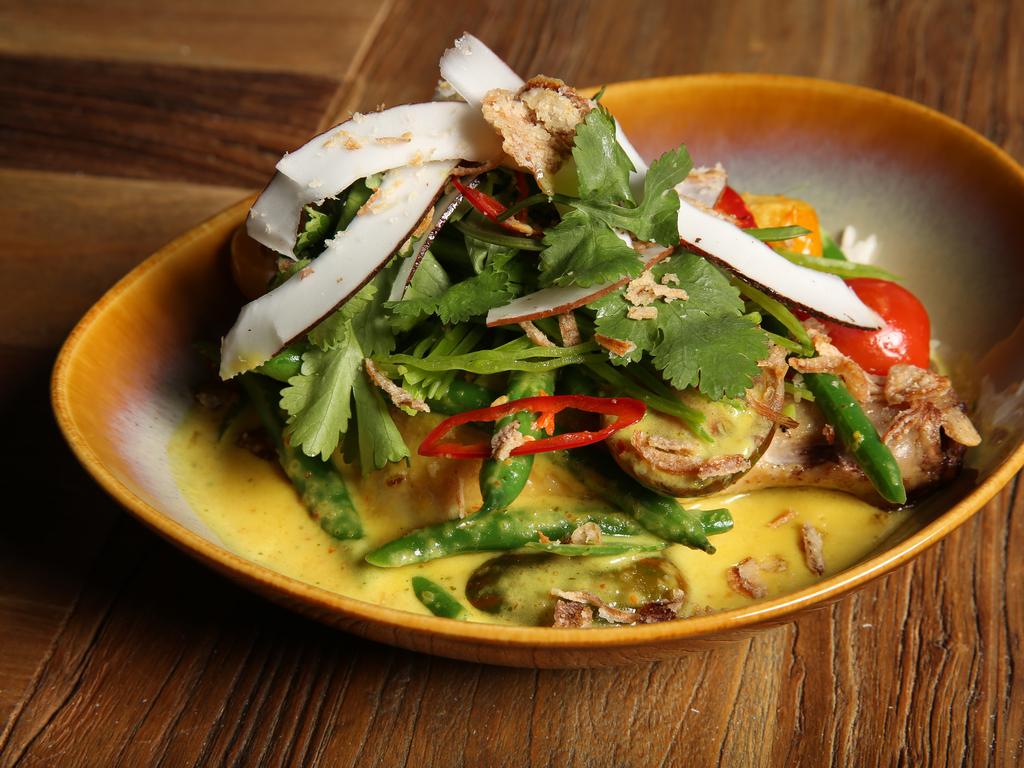 Sticky rice Vietnamese yellow curry with crispy skin roasted chicken, fresh coconut and an Asian herb salad at Makepeace Island. Picture: Lachie Millard