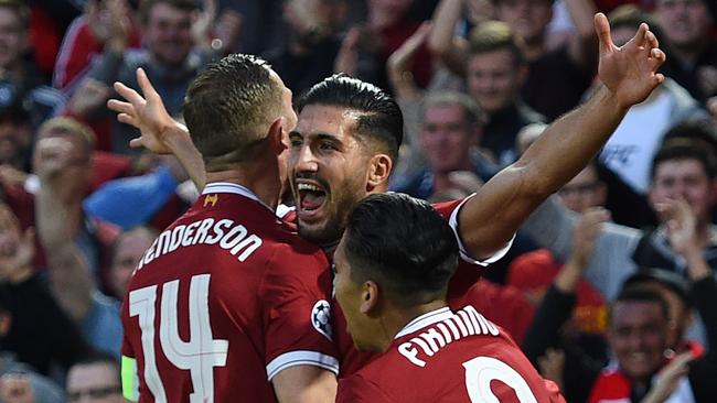 Liverpool's German midfielder Emre Can celebrates a goal with teammates.