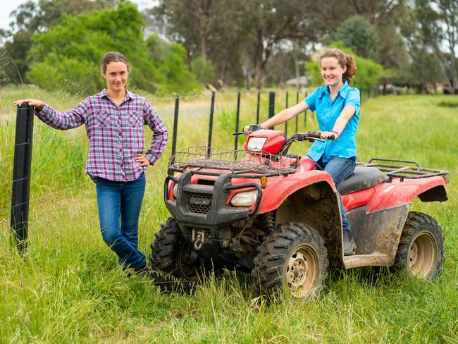 Two of Australia's young farmers of tomorrow, Jindera’s Sarah McLindon with her sister Jessica on their neighbour Harry Chisolm's PLUS post fence line, made of recycled soft plastics by Plastic Forests. Picture: Simon Dallinger