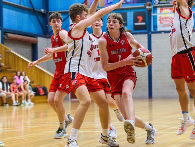 Logan Gibson of Launceston Lightning Red drives against Launceston Lightning Black in the under-18s.