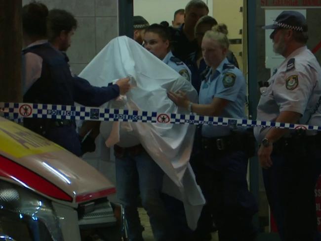 A child believed to be the victim of the attack is shrouded as she is taken into care after the incident. Picture: TNV