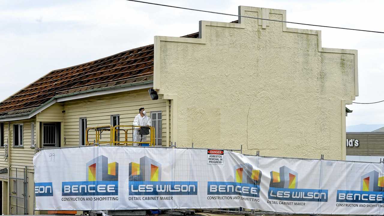 Workers remove the roof from the old firemans hall in Limestone Street in preparation for its demolition to extend the McDonald's carpark. Picture: Rob Williams