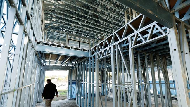 Rajinder Kumar walks through the shell of his home. Picture: Lachie Millard