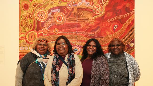 Sisters L-R Yaritji Young, Maringka Tunkin, Tjungkara Ken and Freda Brady who won the Wynne prize, pictured in front of their painting hanging in the Art Gallery of NSW. Picture: Toby Zerna