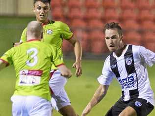 UNDER PRESSURE: Willowburn's Brock Tuesley (right) closes down his New Farm United opponent during Saturday's FFA Cup SEQ round three clash at Clive Berghofer Stadium. Picture: Kevin Farmer