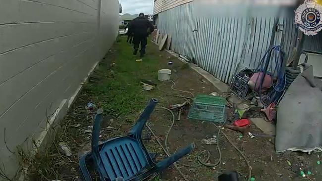 State Flying Squad officers chase an offender into the DFO Shopping Centre on Mulgrave Rd. Picture: QPS