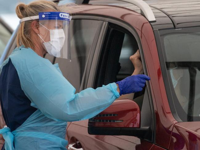 SYDNEY, AUSTRALIA - NewsWire Photos November 29, 2020: A healthcare worker administering a COVID-19 test at a drive through test centre at Bondi Beach, Sydney. Picture: NCA NewsWire / James Gourley