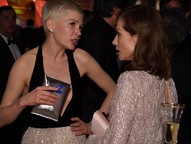 Nominees Michelle Williams and Isabelle Huppert catch up at the Governors Ball in Hollywood. Picture: AFP/Angela Weiss