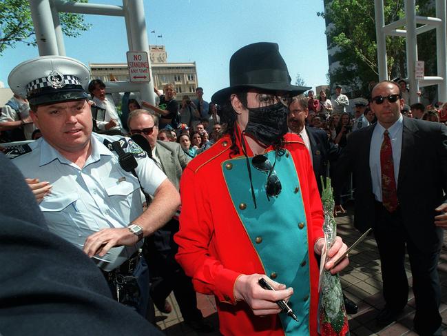 Crowds of people and security surround Michael Jackson as he leaves the Hyatt Hotel in Adelaide in 1996. Presumably the face-mask is for Adelaide’s heavy smog and not an identification deterrent.